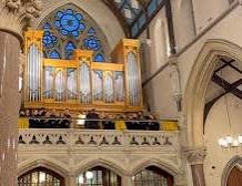 Pipe organ installed in cathedral with rose window